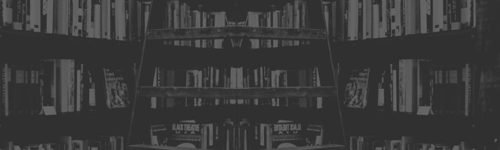 Foto em preto e branco de uma sala grande com várias prateleiras de livros